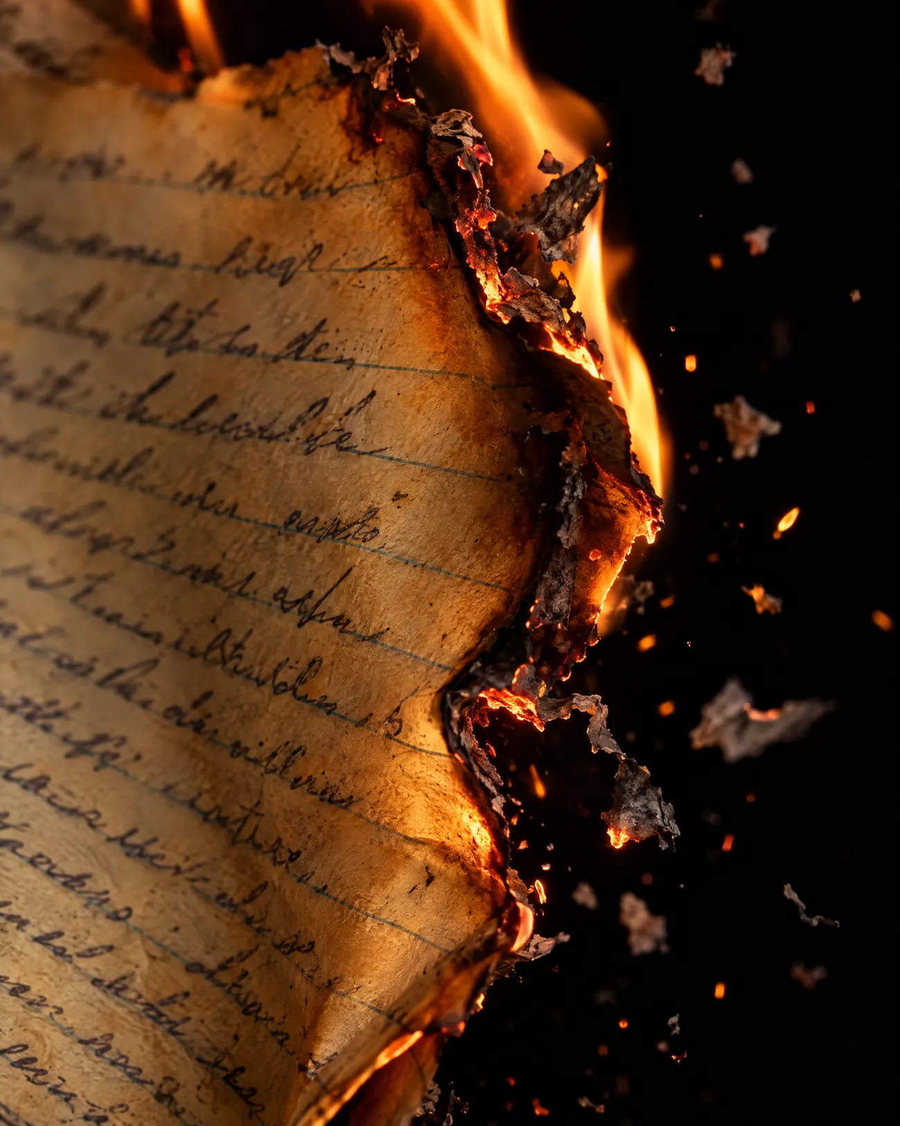 A handwritten note burned down to ash, the last ember fading.